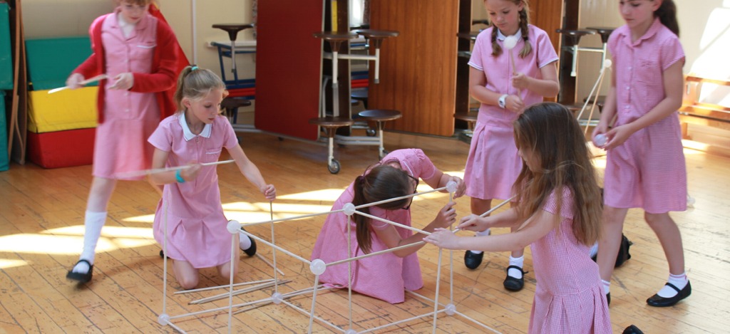 Pupils working together to build a cube