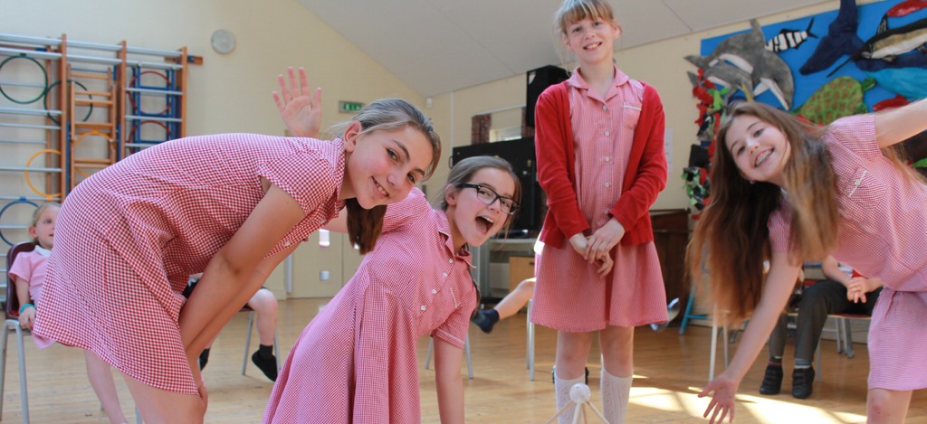 Smiling pupils showing their solution